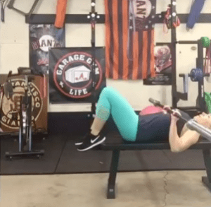 Robin Savala benching in her garage gym