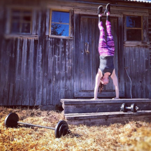 Pole sport athlete Katja Mäkynen practices handstands after some barbell training