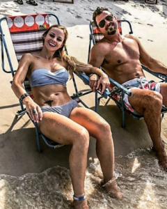 Shed gym owner Charles Forbus and his wife Jodie relaxing on the beach