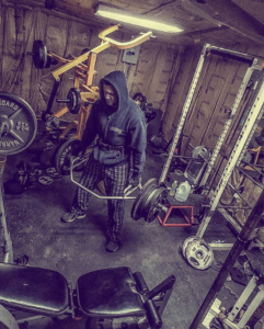 Charles Forbus trapbar deadlifting in his shed gym