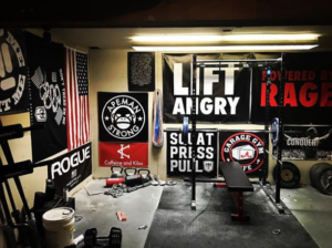 The deadliftpro6 uses banners on the wall of his garage gym to motivate himself