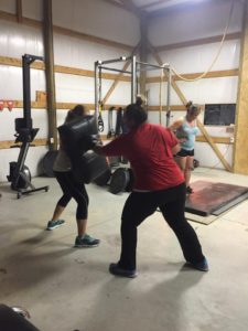 Anna Woods running a training class in her home gym