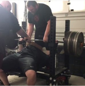 Sammy Sebok and his training partners during a set of board presses