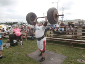 Rocco Walsh does Axle Press in a strongman competition