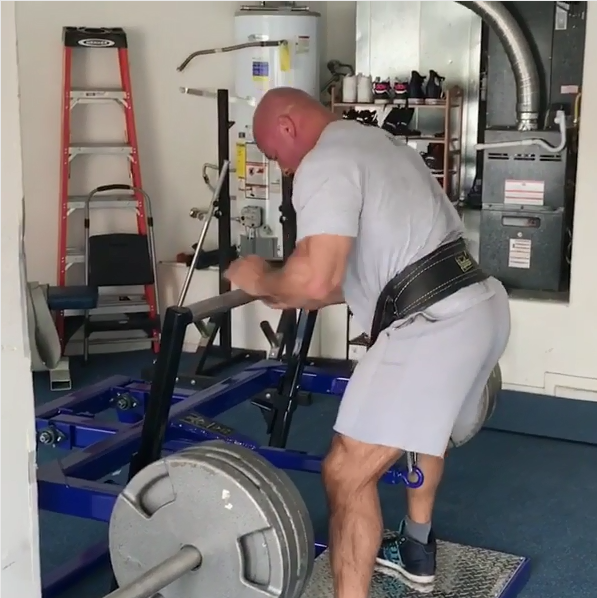 stan efferding uses his belt squat machine in his garage gym